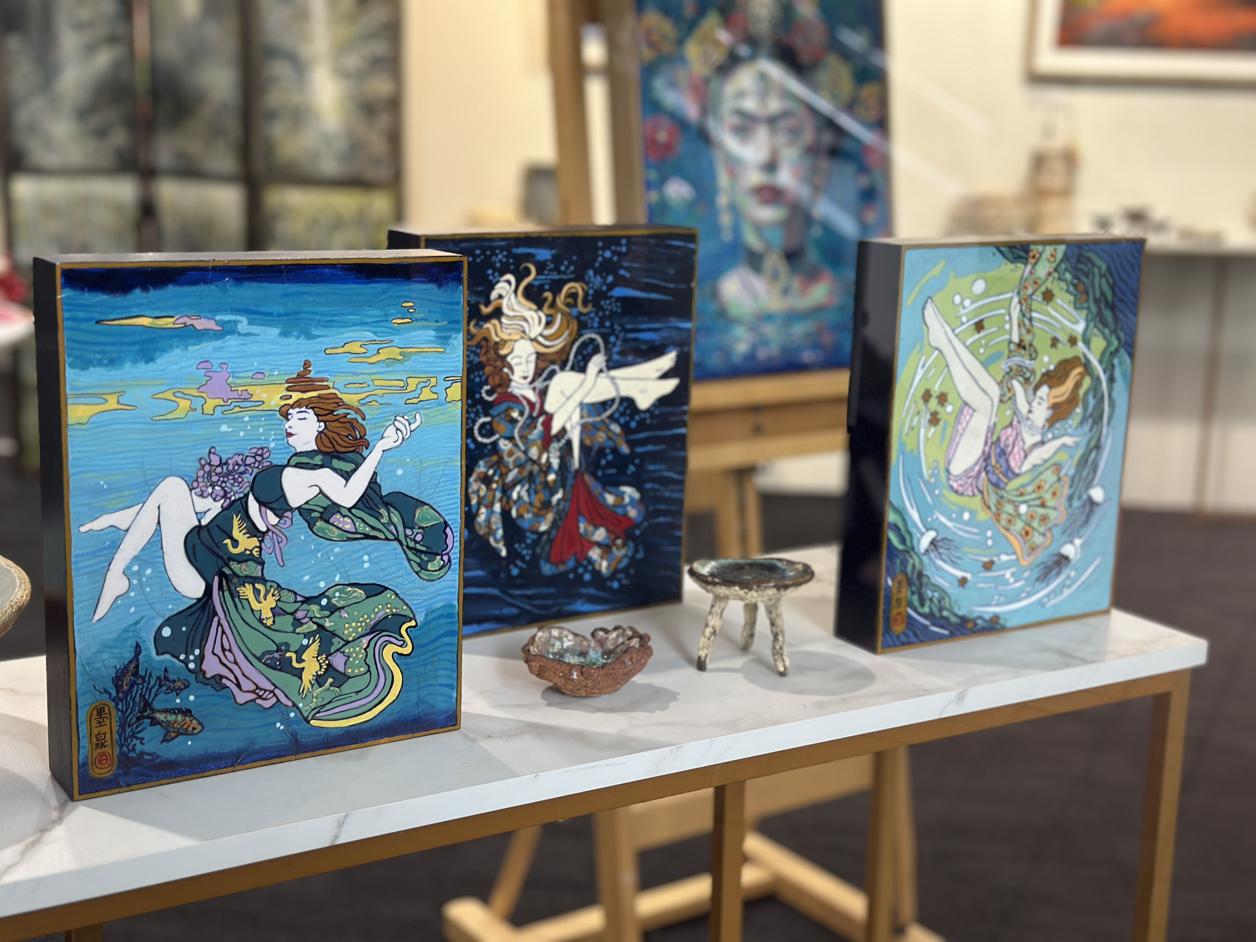 Three of Kerry Inkster’s Ukiyo-e panels standing on a marble shelf at KAB Gallery Neutral Bay